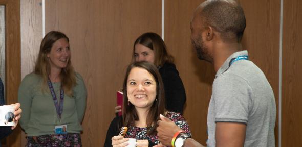 Photo pf BSU staff, standing and having a conversation