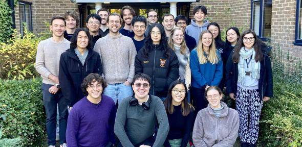 Group photo of BSU PhD students, standing outside and smiling at the camera